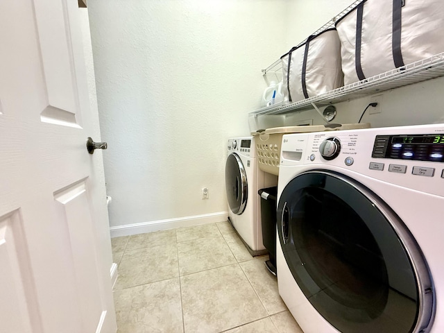 855 Marina Del Ray Ln Unit 2, West Palm Beach, FL 33401 - laundry room with separate washer and dryer, light tile patterned floors, and baseboards