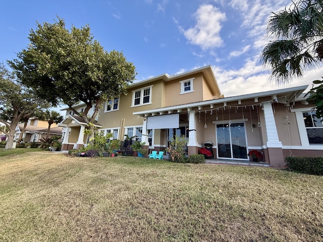 855 Marina Del Ray Ln Unit 2, West Palm Beach, FL 33401 - back of house with stucco siding and a lawn