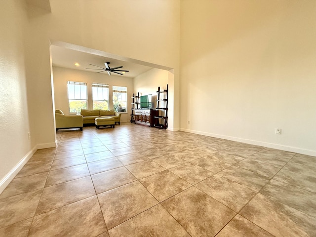 855 Marina Del Ray Ln Unit 2, West Palm Beach, FL 33401 - living area featuring a towering ceiling, light tile patterned flooring, a ceiling fan, and baseboards