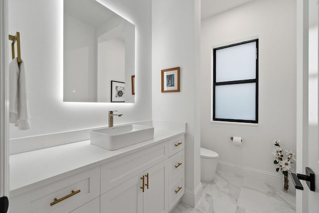 7887 150th Ct N, Palm Beach Gardens, FL 33418 - bathroom featuring marble look tiles, baseboards, vanity, and toilet