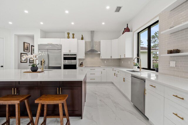 7887 150th Ct N, Palm Beach Gardens, FL 33418 - kitchen featuring wall chimney range hood, appliances with stainless steel finishes, a sink, light marble finish flooring, and tasteful backsplash