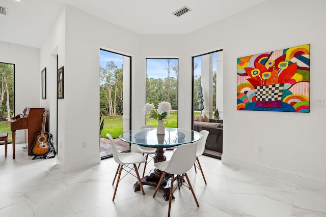 7887 150th Ct N, Palm Beach Gardens, FL 33418 - dining area with plenty of natural light, light marble finish floors, and baseboards