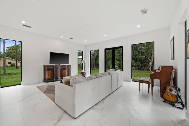 7887 150th Ct N, Palm Beach Gardens, FL 33418 - living room featuring light marble finish floors, plenty of natural light, recessed lighting, and french doors
