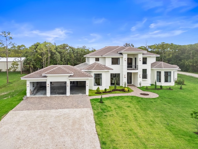 7887 150th Ct N, Palm Beach Gardens, FL 33418 - view of front of house featuring a balcony, driveway, an attached garage, a front yard, and a tiled roof
