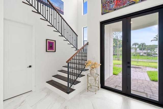 7887 150th Ct N, Palm Beach Gardens, FL 33418 - entryway featuring french doors, plenty of natural light, marble finish floors, and stairway