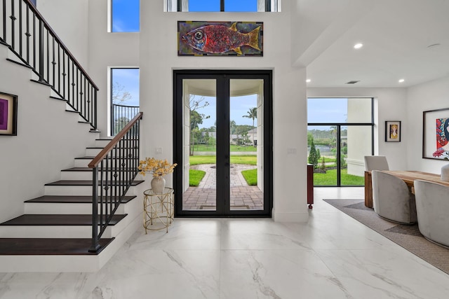 7887 150th Ct N, Palm Beach Gardens, FL 33418 - foyer featuring french doors, healthy amount of natural light, stairs, recessed lighting, and marble finish flooring