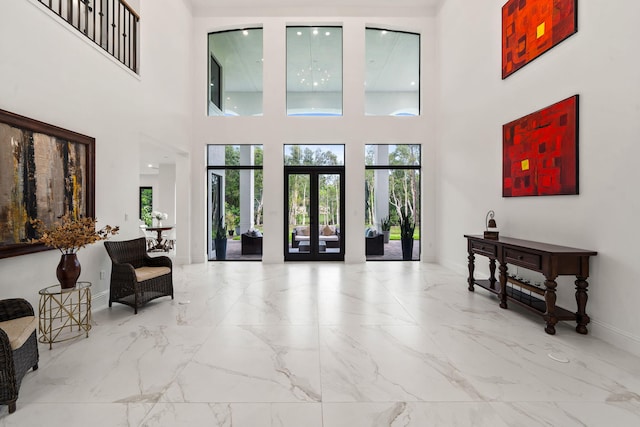 7887 150th Ct N, Palm Beach Gardens, FL 33418 - entrance foyer with marble tiled floors, a towering ceiling, baseboards, and french doors