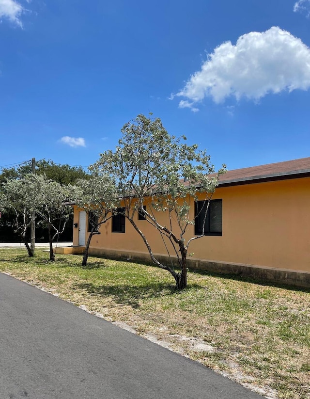 519 NW 3rd Ave Unit 519-521, Hallandale Beach, FL 33009 - view of property exterior featuring stucco siding and a lawn