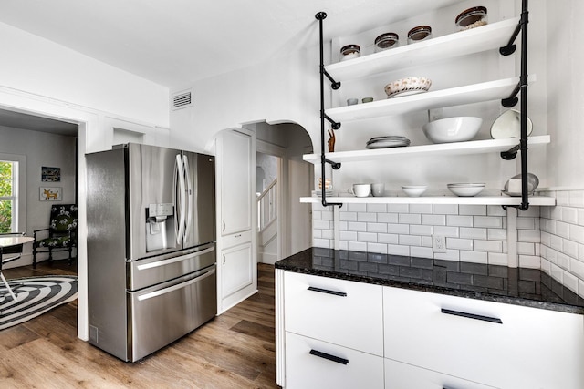 230 Princeton Dr, Lake Worth Beach, FL 33460 - kitchen featuring stainless steel refrigerator with ice dispenser, decorative backsplash, white cabinets, and open shelves