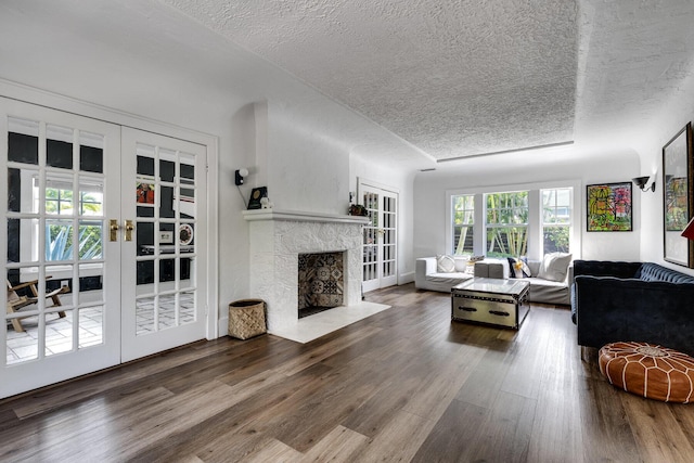 230 Princeton Dr, Lake Worth Beach, FL 33460 - living area featuring a textured ceiling, wood finished floors, and a fireplace with flush hearth