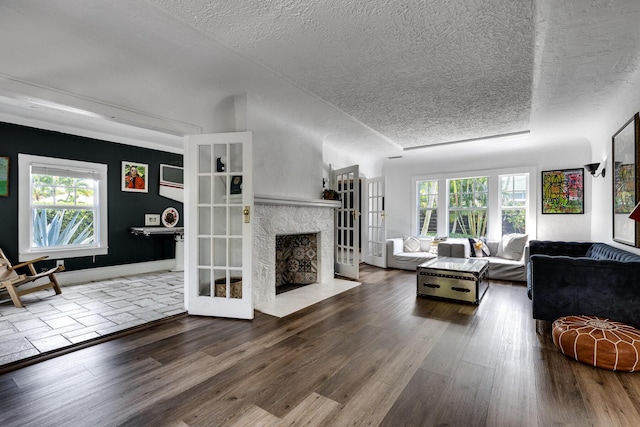 230 Princeton Dr, Lake Worth Beach, FL 33460 - living area with wood finished floors, a textured ceiling, and a high end fireplace