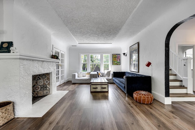 230 Princeton Dr, Lake Worth Beach, FL 33460 - living area with a textured ceiling, wood finished floors, a high end fireplace, and stairway