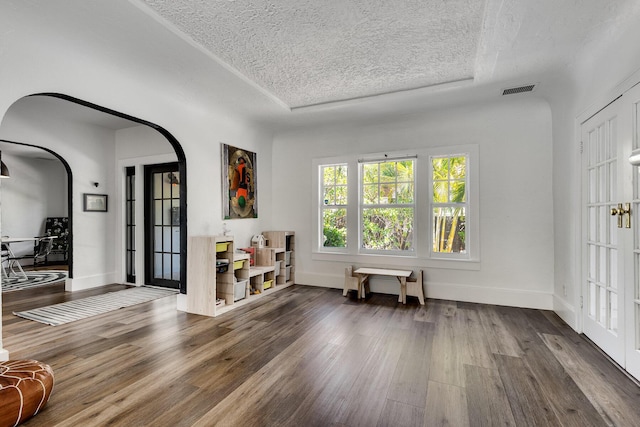 230 Princeton Dr, Lake Worth Beach, FL 33460 - entrance foyer featuring arched walkways, a textured ceiling, and wood finished floors