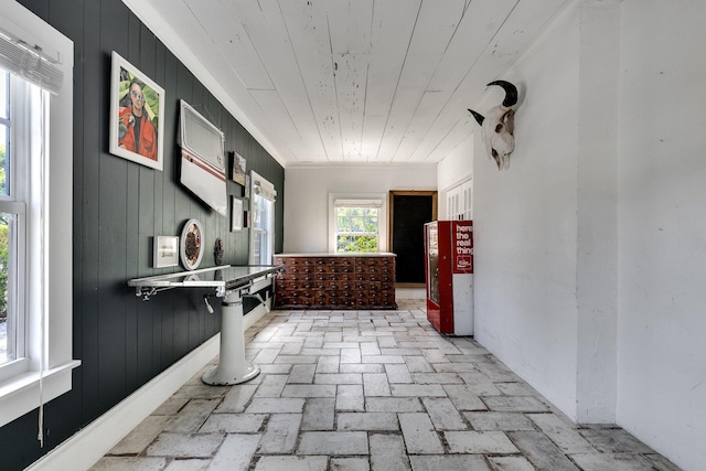 230 Princeton Dr, Lake Worth Beach, FL 33460 - hall featuring brick flooring, wood ceiling, and wood walls