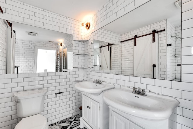 230 Princeton Dr, Lake Worth Beach, FL 33460 - full bathroom with tile walls, two vanities, and decorative backsplash