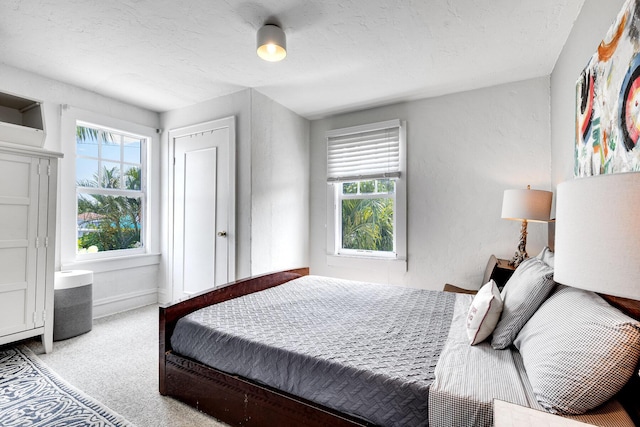 230 Princeton Dr, Lake Worth Beach, FL 33460 - carpeted bedroom featuring multiple windows and a textured ceiling