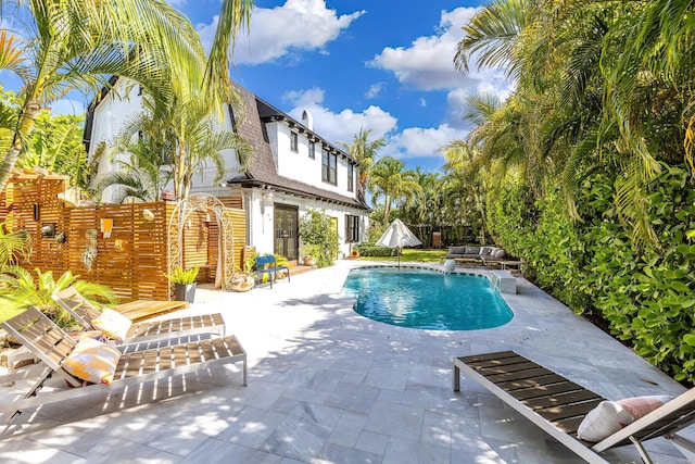 230 Princeton Dr, Lake Worth Beach, FL 33460 - swimming pool featuring a patio area