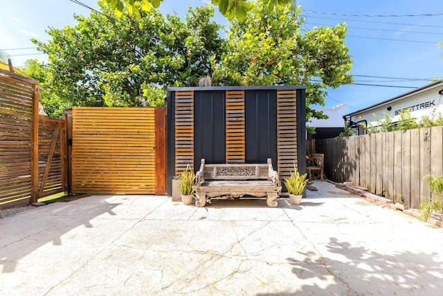 230 Princeton Dr, Lake Worth Beach, FL 33460 - fenced backyard with a patio area and an outbuilding