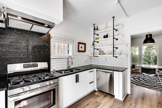 230 Princeton Dr, Lake Worth Beach, FL 33460 - kitchen with stainless steel appliances, range hood, white cabinets, tasteful backsplash, and open shelves