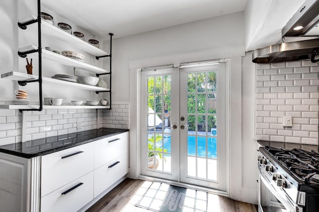 230 Princeton Dr, Lake Worth Beach, FL 33460 - kitchen with dark countertops, open shelves, backsplash, and french doors