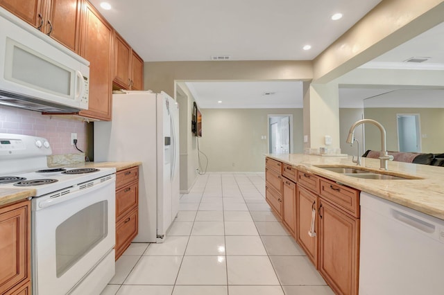 1197 Belmore Ter, Wellington, FL 33414 - kitchen with white appliances, a sink, decorative backsplash, brown cabinetry, and light tile patterned floors