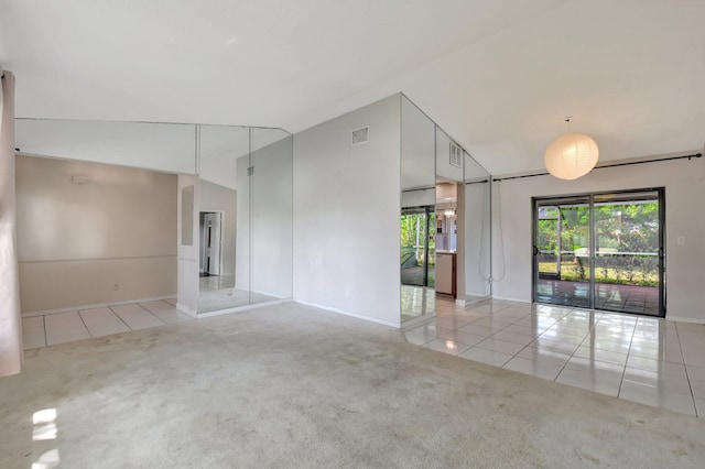 1197 Belmore Ter, Wellington, FL 33414 - carpeted empty room with plenty of natural light, tile patterned floors, baseboards, and lofted ceiling