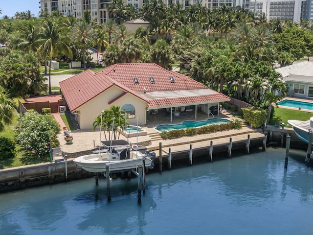 3819 N Ocean Dr, Singer Island, FL 33404 - dock area with boat lift, a community pool, a patio area, and a hot tub