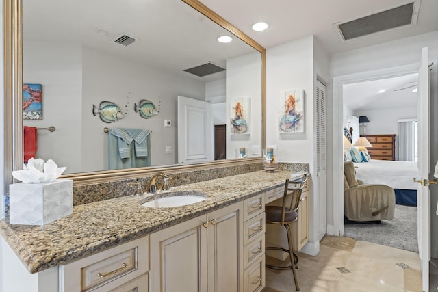 3819 N Ocean Dr, Singer Island, FL 33404 - ensuite bathroom featuring vanity, tile patterned flooring, and recessed lighting