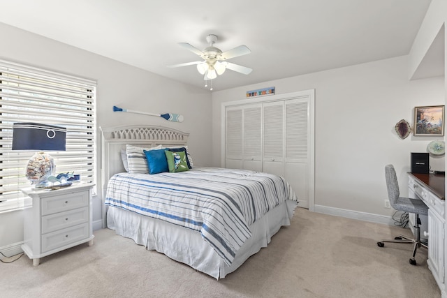 3819 N Ocean Dr, Singer Island, FL 33404 - bedroom featuring a closet, light carpet, a desk, baseboards, and a ceiling fan