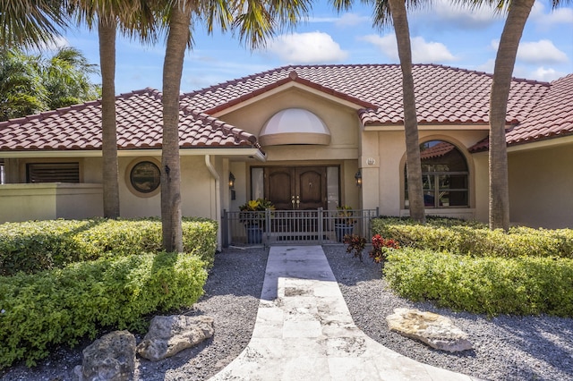 3819 N Ocean Dr, Singer Island, FL 33404 - view of front of house featuring a tile roof and stucco siding