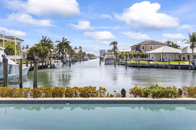 3819 N Ocean Dr, Singer Island, FL 33404 - view of swimming pool featuring a water view and a dock