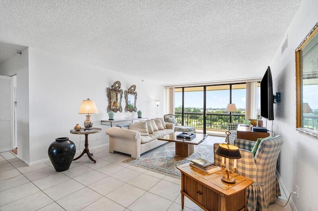 1900 Consulate Pl Unit 402, West Palm Beach, FL 33401 - living room featuring a textured ceiling, light tile patterned floors, and baseboards