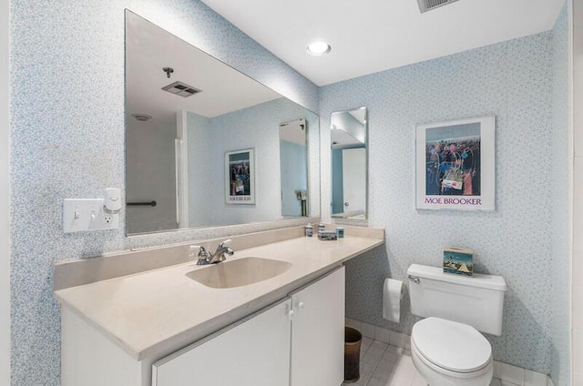 1900 Consulate Pl Unit 402, West Palm Beach, FL 33401 - bathroom with vanity, toilet, tile patterned floors, and baseboards