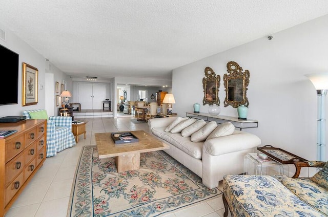 1900 Consulate Pl Unit 402, West Palm Beach, FL 33401 - living area with light tile patterned floors and a textured ceiling