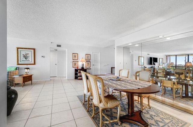1900 Consulate Pl Unit 402, West Palm Beach, FL 33401 - dining space with light tile patterned flooring, a textured ceiling, baseboards, and recessed lighting