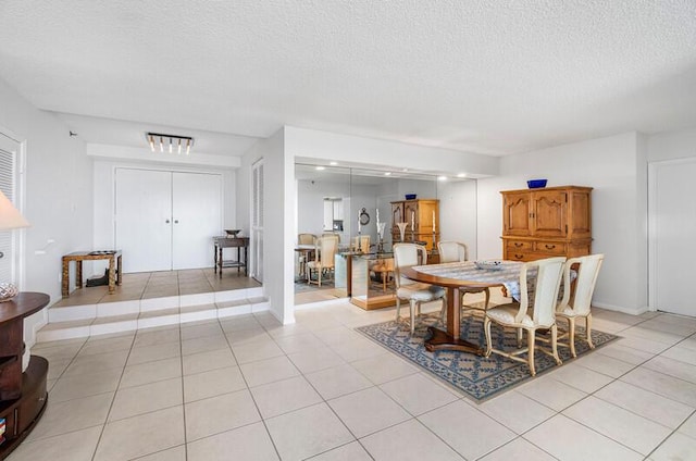 1900 Consulate Pl Unit 402, West Palm Beach, FL 33401 - dining room with a textured ceiling and light tile patterned floors