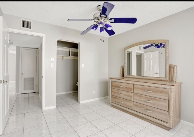 4821 NW 22nd Ct Unit 111, Lauderhill, FL 33313 - bedroom featuring a closet, a textured ceiling, baseboards, a ceiling fan, and light tile patterned flooring