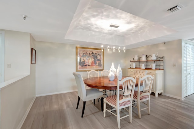 20100 Boca W Dr Unit 163, Boca Raton, FL 33434 - dining room with a tray ceiling, wood finished floors, and baseboards