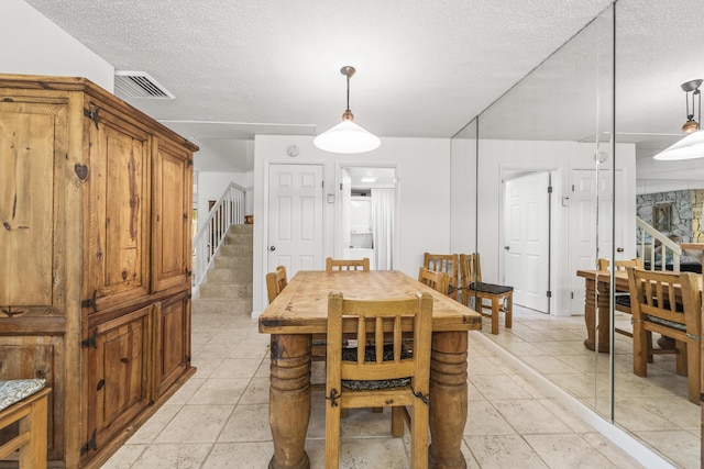 2513 25th Ln, Palm Beach Gardens, FL 33418 - dining space featuring stairs and a textured ceiling