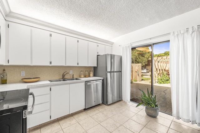 2513 25th Ln, Palm Beach Gardens, FL 33418 - kitchen featuring stainless steel appliances, a sink, a textured ceiling, light countertops, and white cabinets