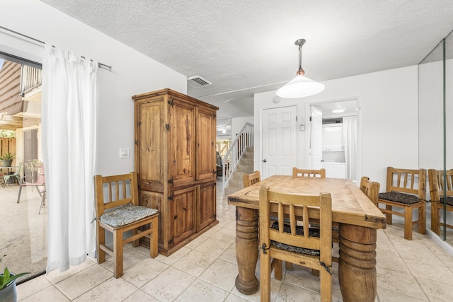 2513 25th Ln, Palm Beach Gardens, FL 33418 - dining area with stairs and a textured ceiling