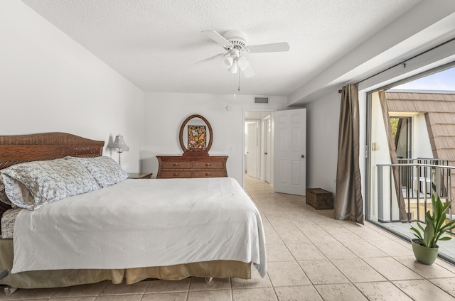 2513 25th Ln, Palm Beach Gardens, FL 33418 - bedroom featuring a ceiling fan, a textured ceiling, light tile patterned floors, and access to exterior