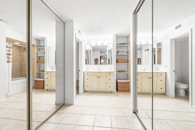 2513 25th Ln, Palm Beach Gardens, FL 33418 - full bath with toilet, a textured ceiling, vanity, tile patterned floors, and shower / tub combination