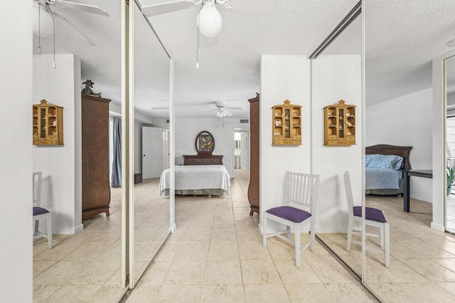 2513 25th Ln, Palm Beach Gardens, FL 33418 - bedroom with a textured ceiling, a ceiling fan, and baseboards