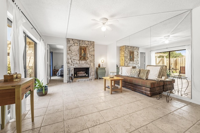 2513 25th Ln, Palm Beach Gardens, FL 33418 - living room with ceiling fan, a textured ceiling, and a fireplace