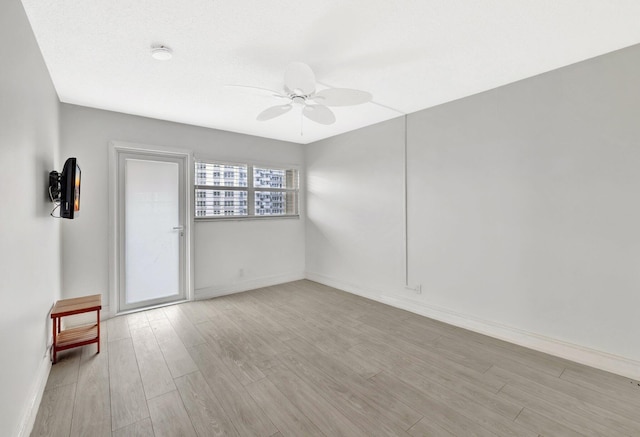 328 N Ocean Blvd Unit 404, Pompano Beach, FL 33062 - empty room with a ceiling fan, wood finished floors, and baseboards