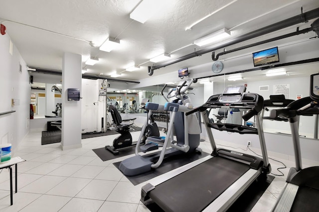 328 N Ocean Blvd Unit 404, Pompano Beach, FL 33062 - exercise room featuring a textured ceiling and light tile patterned floors