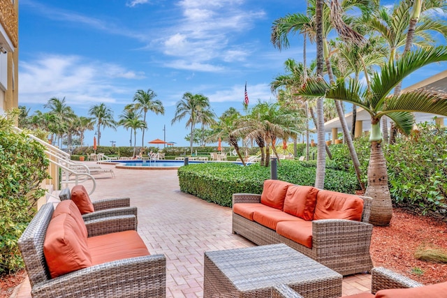 328 N Ocean Blvd Unit 404, Pompano Beach, FL 33062 - view of patio / terrace with an outdoor living space and a community pool