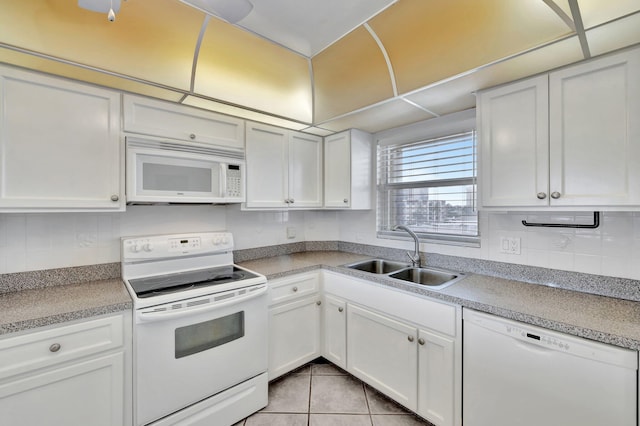 328 N Ocean Blvd Unit 404, Pompano Beach, FL 33062 - kitchen with white appliances, a sink, tasteful backsplash, white cabinetry, and light tile patterned floors