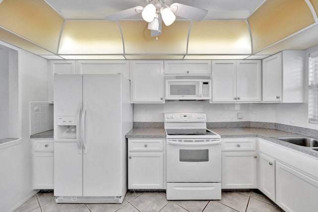 328 N Ocean Blvd Unit 404, Pompano Beach, FL 33062 - kitchen with white appliances, light tile patterned floors, and white cabinets